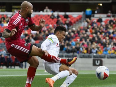 Ottawa Fury FC player Kyle Porter (19) takes a shot as New York Cosmos player David Diosa (21) tries to block the ball during the NASL match between Fury FC and Cosmos held at TD Place on Sunday, Oct. 9, 2016. (James Park)