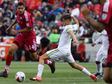 Ottawa Fury FC player Onua Thomas Obasi (14) dribbles the ball as New York Cosmos player Ruben Bover (15) chases the ball during the NASL match between Fury FC and Cosmos held at TD Place on Sunday, Oct. 9, 2016.