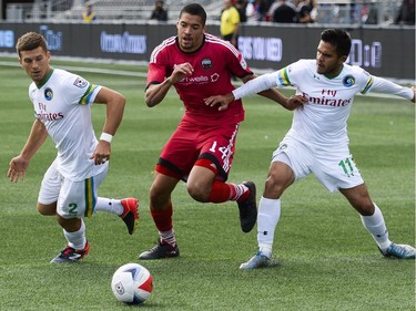 Ottawa Fury FC player Onua Thomas Obasi (14) fights for possession as two New York Cosmos players Ryan Richter (2) and Andres Flores (11) tries to stop him during the NASL match between Fury FC and Cosmos held at TD Place on Sunday, Oct. 9, 2016. (James Park)