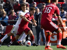 Ottawa Fury FC player Ryan Williams (7) dribbles past New York Cosmos player Ryan Richter (2) during the NASL match between Fury FC and Cosmos held at TD Place on Sunday, Oct. 9, 2016.