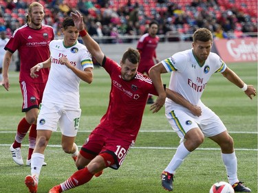 Ottawa Fury FC player Thomas Stewart (16) and New York Cosmos player Ryan Richter (2) fight for possession during the NASL match between Fury FC and Cosmos held at TD Place on Sunday, Oct. 9, 2016. (James Park)