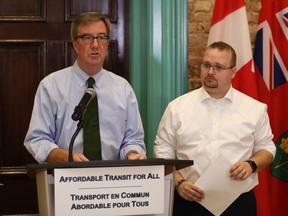 Ottawa Mayor Jim Watson, left, and transit commission chair Coun. Stephen Blais announce the new low-income pass plan for OC Transpo riders.