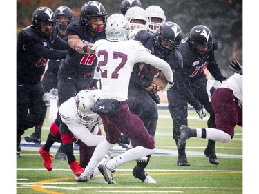 The Ravens' Jayde Rowe gets tackled by Cody Cranston.