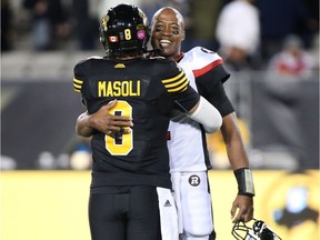 Ottawa Redblacks quarterback Henry Burris receives a hug from Hamilton Tiger-Cats quarterback Jeremiah Masoli at the end of the game in Hamilton on Friday, Oct. 14, 2016.