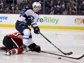 Ottawa Senators' Fredrik Claesson (33) breaks up a possible breakaway opportunity for Winnipeg Jets' Kyle Connor (41) during second period pre-season NHL hockey in Winnipeg, Monday, October 3, 2016.