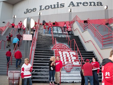 Fans pose in front of a mural painted on the stairs outside Joe Louis Arena prior to the game.