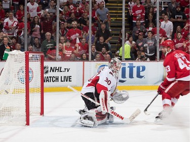 Darren Helm #43 of the Detroit Red Wings scores a first period goal on Andrew Hammond #30 of the Ottawa Senators.