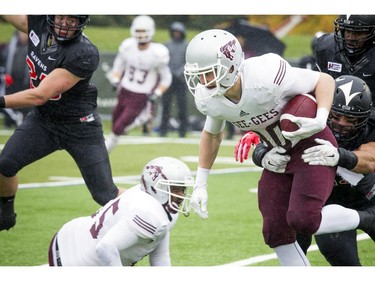 The Gee-Gees' Greg Cherniak tries to get away from Carleton's Leon Cenerini.