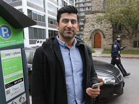 City Parking founder Amin Dadan poses for a photo near city hall on Monday.