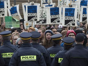 Police stop oil pipeline protesters from using a gate to enter Parliament Hill Monday October 24, 2016 in Ottawa. The protesters were allowed to use another entrance unobstructed.