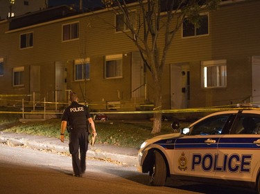 Police survey the scene of an apparent homicide outside of 1411 Rosenthal Avenue off of Merivale Rd in the Carlington neighbourhood.