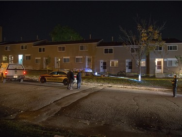 Police survey the scene of an apparent homicide outside of 1411 Rosenthal Ave off of Merivale Rd in the Carlington neighbourhood.   Wayne Cuddington/ Postmedia