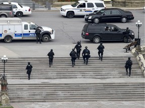 Police teams move towards Centre Block on Wednesday, Oct. 22, 2014. An attacker was eventually shot dead inside the Hall of Honour.
