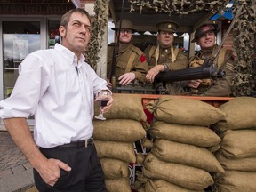 Preston Street il Primo restaurant owner Craig Pedersen on the front steps of his business with First World War Re-enactors (L-R) Daniel Ferland, Rich Lees, and Terry Hunter in a machine gun nest.