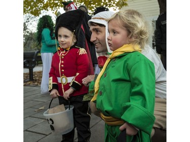Prime Minister Justin Trudeau and his youngest child Hadrien, right, dressed as The Little Prince, pose for a photo with 4 year old Max Anson, dressed a Governor General's Foot Guard, during Halloween celebrations on the grounds of Rideau Hall on Monday October 31, 2016. Errol McGihon/Postmedia
