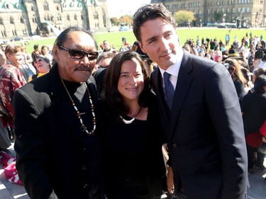 Prime Minister Justin Trudeau (right), along with a number of his female cabinet ministers, made a surprise visit to a vigil for missing and murdered Indigenous women, girls and Two-Spirit people (MMIWG2S) Tuesday (Oct. 4, 2016) on Parliament Hill.  Here, he poses with Sytukie Joamie - the cousin of famous Inuit artist, Annie Pootoogook, who recently turned up dead in the Rideau River - and  Attorney General and Minister of Justice, Jody Wilson-Raybould (centre).