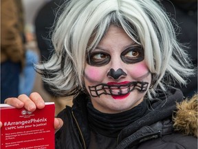 PSAC members, some wearing costumes like Anne Marie Grondin, demonstrate in front of Prime Minister Justin Trudeau's offices in the Langevin Block at Wellington and Elgin Streets on Monday.