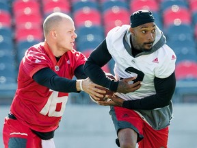 Quarterback Brock Jensen hands off the ball to Travon Van as the Ottawa Redblacks practice at TD Place in advance of their next game on Friday.