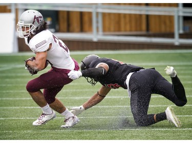 The Ravens' Nathaniel Hamlin tries to stop the Gee-Gees' Bryce Vieira.