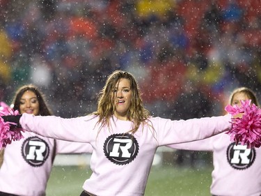 Redblack cheerleaders get soaked in the rain during the first half.