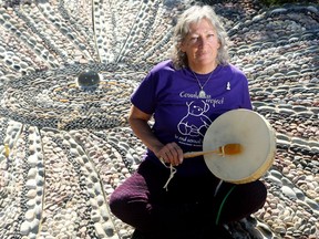 Sexual abuse survivor, Roberta Della-Picca, plays her native drum and displays the Countdown Public Art Project, to be unveiled Saturday, Oct. 15, 2016) in Eganville.