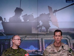 Lieutenant-General Stephen Bowes, left, and Brigadier-General Peter Dawe speak as the Canadian Armed Forces provides an update on Operation IMPACT in the Middle East during a press conference at National Defence headquaters in Ottawa on Thursday, Oct. 6, 2016.