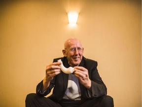 Tal Golesworthy, a British engineer, holds a copy of the brace that he designed to fix his own faulty aorta after speaking at a medical conference in Ottawa on Wednesday.
