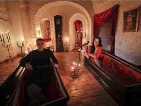 Tami Varma and her brother Robin, the grandchildren of Devendra Varma, a scholar of English gothic tales and an expert in vampire lore, pose in coffins at Bran Castle, in Bran, Romania, Monday, Oct. 31, 2016.