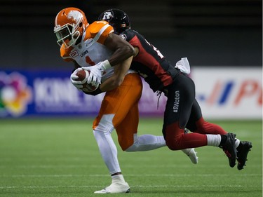 B.C. Lions' Terrell Sinkfield Jr., left, is tackled by Ottawa Redblacks' Mitchell White after making a reception during the first half of a CFL football game in Vancouver, B.C., on Saturday October 1, 2016.