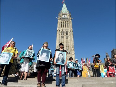 The faces of missing and murdered native women are lined up on the steps of Parliament Hill. Prime Minister Justin Trudeau, along with a number of his female cabinet ministers, made a surprise visit to a vigil for missing and murdered Indigenous women, girls and Two-Spirit people (MMIWG2S) Tuesday (Oct. 4, 2016) on Parliament Hill.