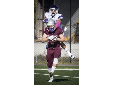 The Mustangs' Simon Bahru gets a piggyback ride as he tries to stop the Gee-Gees' Mitchell Baines.