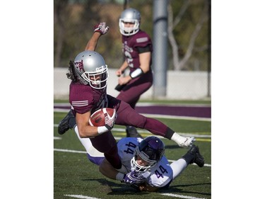 The Gee-Gees' Bryce Vieira unsuccessfully tries to get away from the Mustang's Philippe Dion.