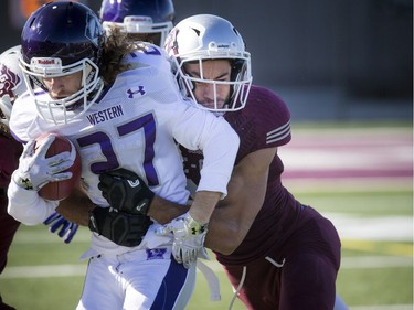 The Mustangs' Mackenzie Ferguson tries to break away from a Gee-Gees player.