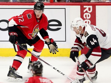 Thomas Chabot looks for the puck with Kevin Connauton defending in the second period as the Ottawa Senators take on the Arizona Coyotes in NHL action at the Canadian Tire Centre.