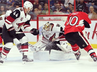 Tom Pyatt gets the puck past Mike Smith with Kevin Connauton looking on in the first period.