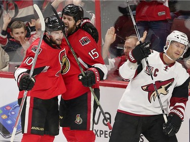 Tom Pyatt (L) and Zack Smith celebrate sack's short handed goal as Shane Doan (R) skates away in the second period as the Ottawa Senators take on the Arizona Coyotes in NHL action at the Canadian Tire Centre.  photo by Wayne Cuddington/ Postmedia