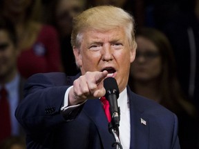 TOPSHOT - Republican presidential nominee Donald Trump speaks during a rally at Mohegan Sun Arena in Wilkes-Barre, Pennsylvania on October 10, 2016. /