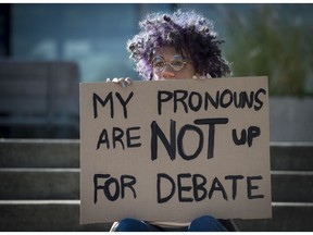Quinn Valkyrie holds a sign in protest at Prof. Jordan Peterson, who has refused to refer to transgender people by their chosen pronouns, at University of Toronto.