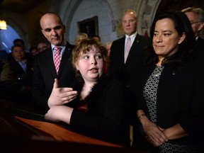 Charlie Lowthian-Rickert, who is transgender, speaks alongside Justice Minister Jody Wilson-Raybould, right, after the introduction of new legislation on gender identity and expression in May.