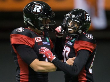 Ottawa Redblacks' quarterback Trevor Harris, left, and Chris Williams celebrate Williams' touchdown against the B.C. Lions during the first half of a CFL football game in Vancouver, B.C., on Saturday October 1, 2016.