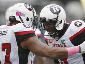 The Ottawa Redblacks' Mossis Madu Jr., left, and Ernest Jackson celebrate Madu's touchdown against the Winnipeg Blue Bombers during the first half of CFL action in Winnipeg Saturday, Oct. 29, 2016.