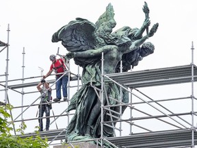 Workers install scaffolding around the National War Memorial as repair work to the structure continues.