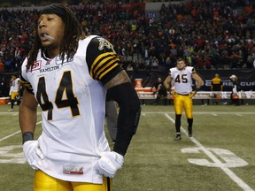 Dejected Hamilton Tiger-Cats #44 Taylor Reed and #45 Arnaud Gascon-Nadon walk off the field after losing  102nd Canadian Football League Grey Cup championship game to the Calgary Stampeders 20-16 in Vancouver on Sunday Nov. 30, 2104.