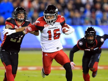 TORONTO, ON - NOVEMBER 27:  Marquay McDaniel #16 of the Calgary Stampeders fends off Mitchell White #21 of the Ottawa Redblacks during the first half of the 104th Grey Cup Championship Game at BMO Field on November 27, 2016 in Toronto, Canada.