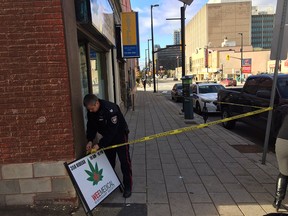 Ottawa Police put up tape at Wee Medical Dispensary Society on Rideau Street.