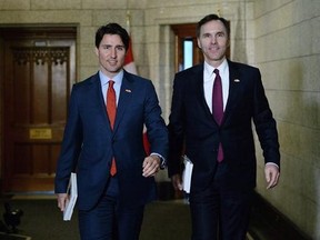 Prime Minister Justin Trudeau will take an important step Monday toward his ambitious goal of turning Canada into a magnet for foreign investment when he meets with some of the world&#039;s most powerful institutional investors with trillions of dollars at their disposal. Minister of Finance Bill Morneau, right, is accompanied by the Prime Minister as he makes his way to deliver the federal budget, in Ottawa in a March 22, 2016, file photo.