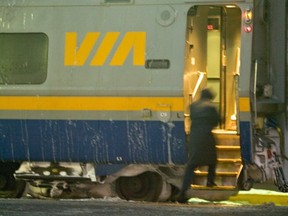 A conductor boards a VIA Rail train at the Ottawa Station.
