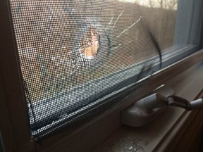 A bullethole is seen in a window after a gun accidentally discharged during a cleaning in Val-des-Monts on Saturday, Nov. 19, 2016. MRC des Collines photo