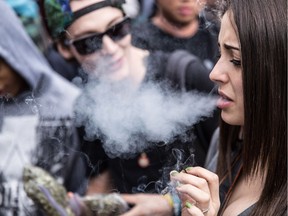 Advocates for the legalization of recreational pot, such as this woman at a rally in Vancouver in 2014, will have to wait to find out what's in a task force report making recommendations to the federal government on how to legalize marijuana.