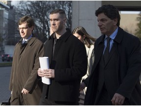 Adam Picard (centre) exits the Ottawa Courthouse with his lawyer Lawrence Greenspon (R) on Nov. 15, 2016.